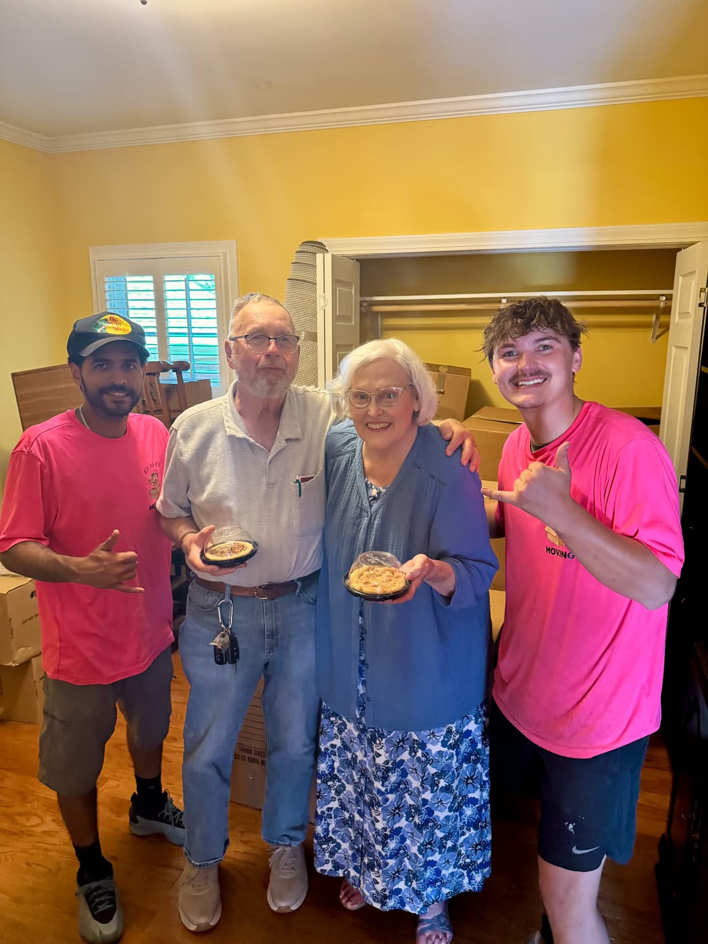 EZ As Pie movers with a senior couple holding their free pies after a stress-free move