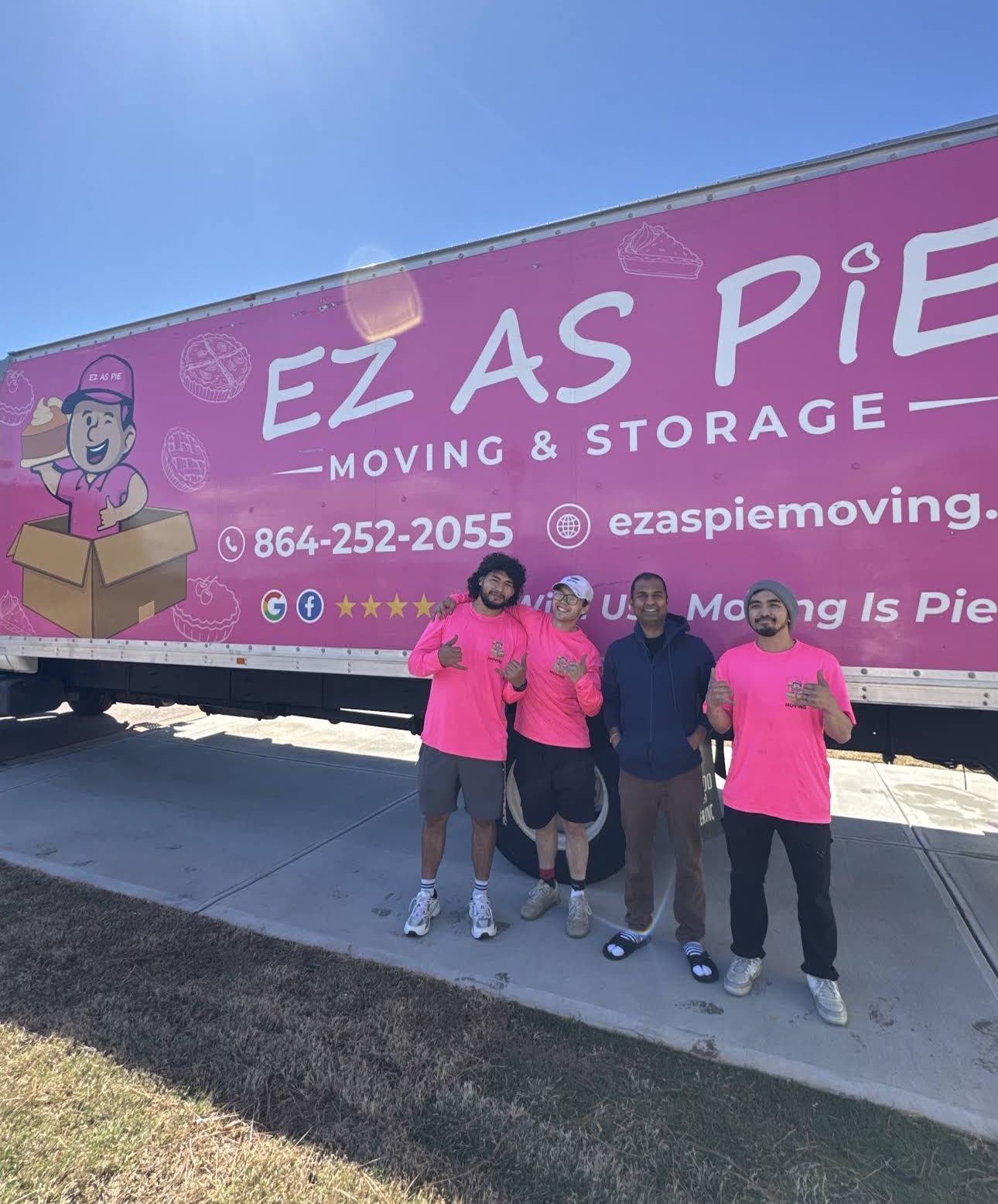 EZ As Pie movers with a customer in front of their pink moving truck
